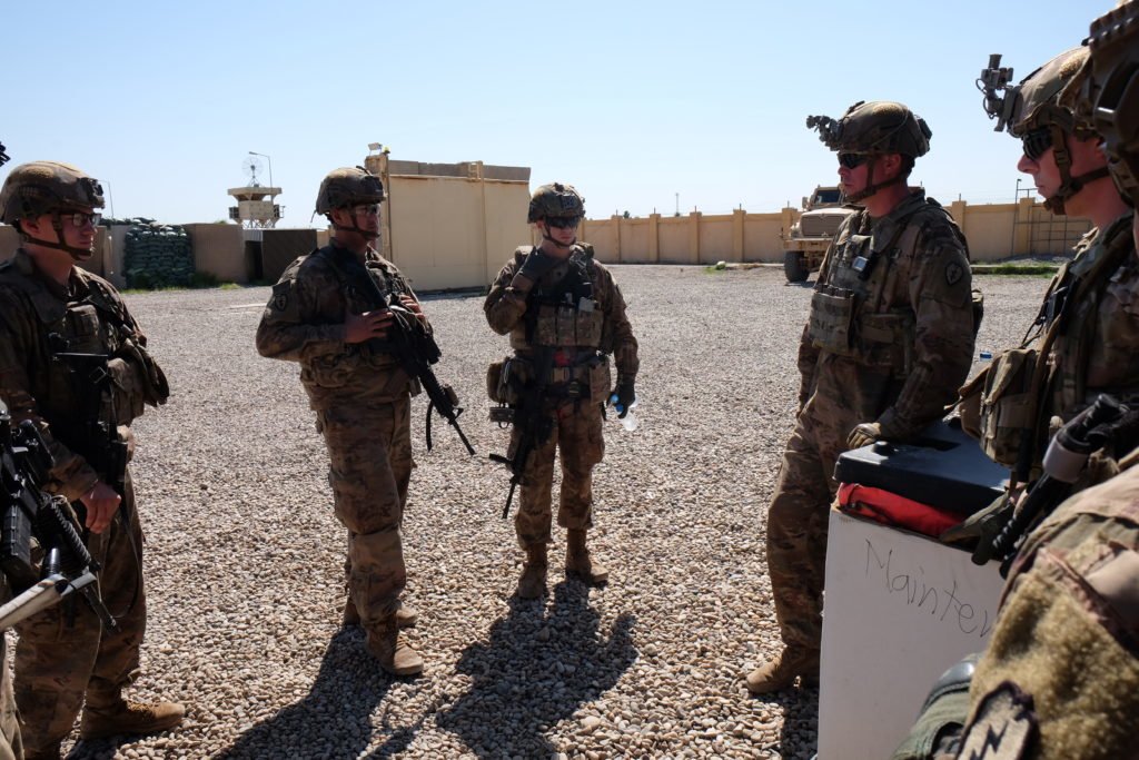 Jacques, right, briefs his scouts before a perimeter patrol. Photo by Kevin Knodell/Coffee or Die.