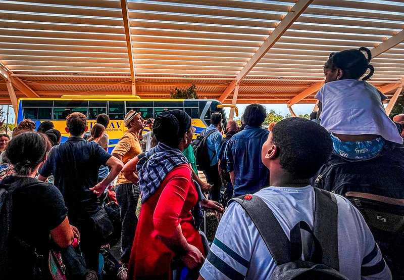 French nationals gather as they wait to be airlifted back to France on a French military aircraft, at the international Airport in Niamey, Niger.