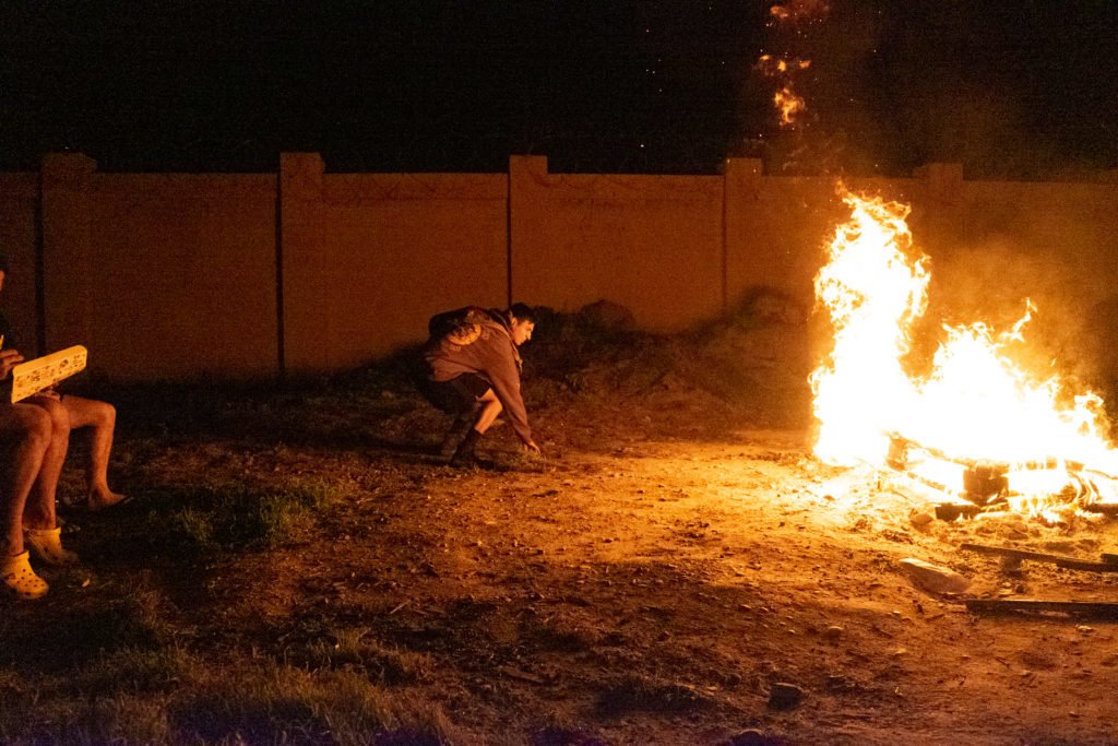 Soldiers from Echo company burn wood pallets outside of the warehouse that serves as their barracks. A rocket went through their roof on the night of December 27, 2019 but miraculously killed no one. Photo by Kevin Knodell/Coffee or Die.