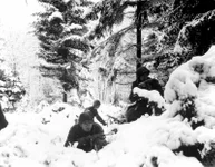 American infantrymen of the 290th Regiment fight in fresh snowfall near Amonines, Belgium, Jan. 4, 1945. U.S. Army photo.