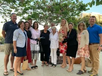 Nancy C. Schrum, front left, and Pat Mearns, center, celebrate with others after the Coronado city council approved the construction of the League of Wives Memorial in 2022. Photo courtesy of the League of Wives Memorial Project.