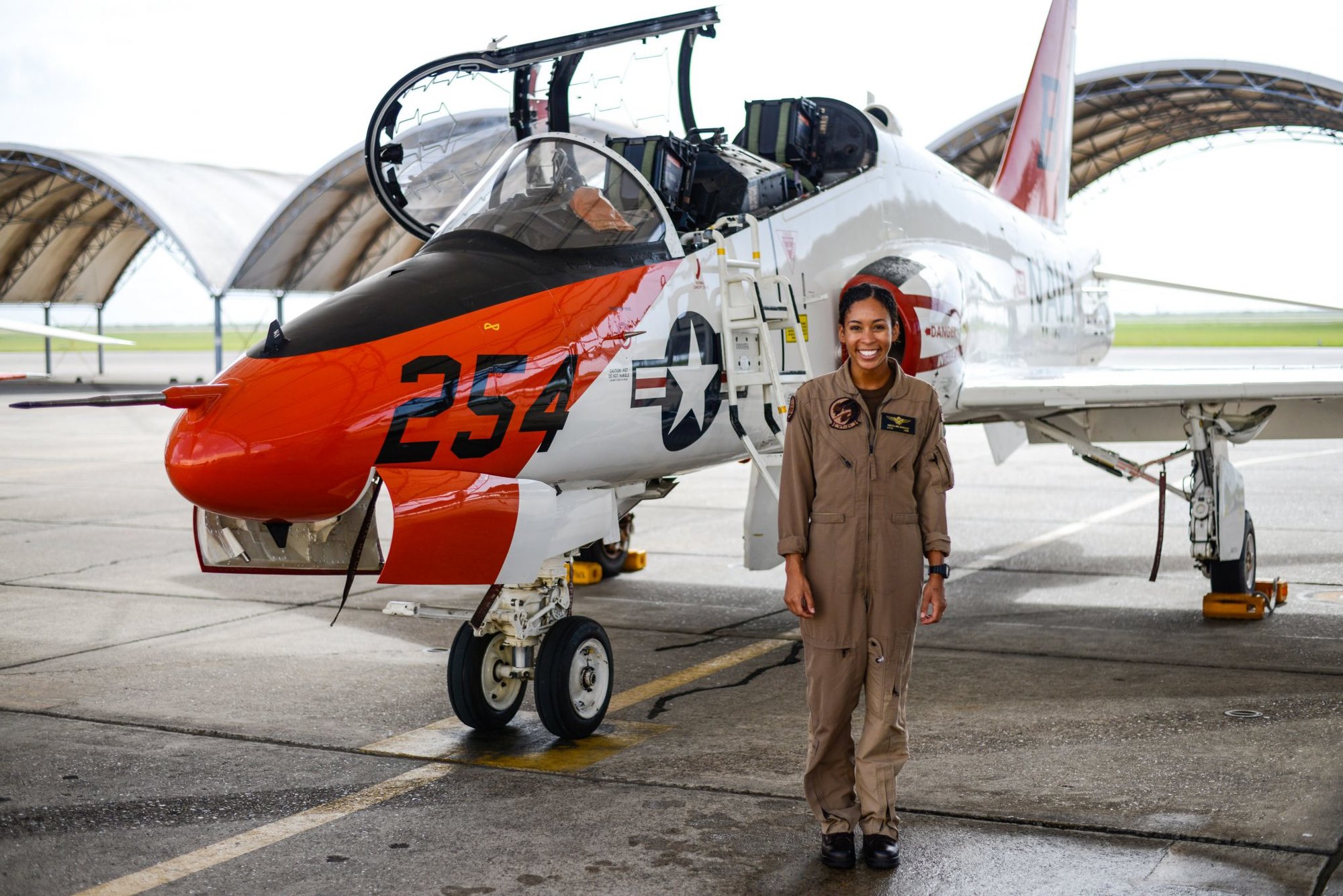 KINGSVILLE, Texas (July 7, 2020) Student Naval Aviator Lt. j.g. Madeline Swegle, assigned to the Redhawks of Training Squadron (VT) 21 at Naval Air Station Kingsville, Texas, stands by a T-45C Goshawk training aircraft following her final flight to complete the undergraduate Tactical Air (Strike) pilot training syllabus, July 7, 2020. Swegle is the Navy's first known Black female strike aviator and will receive her Wings of Gold during a ceremony July 31. (U.S. Navy photo by Lt.j.g. Luke Redito/Released)