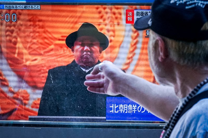 A person watches a TV showing a news program on North Korea's missile launch Wednesday, July 12, 2023.