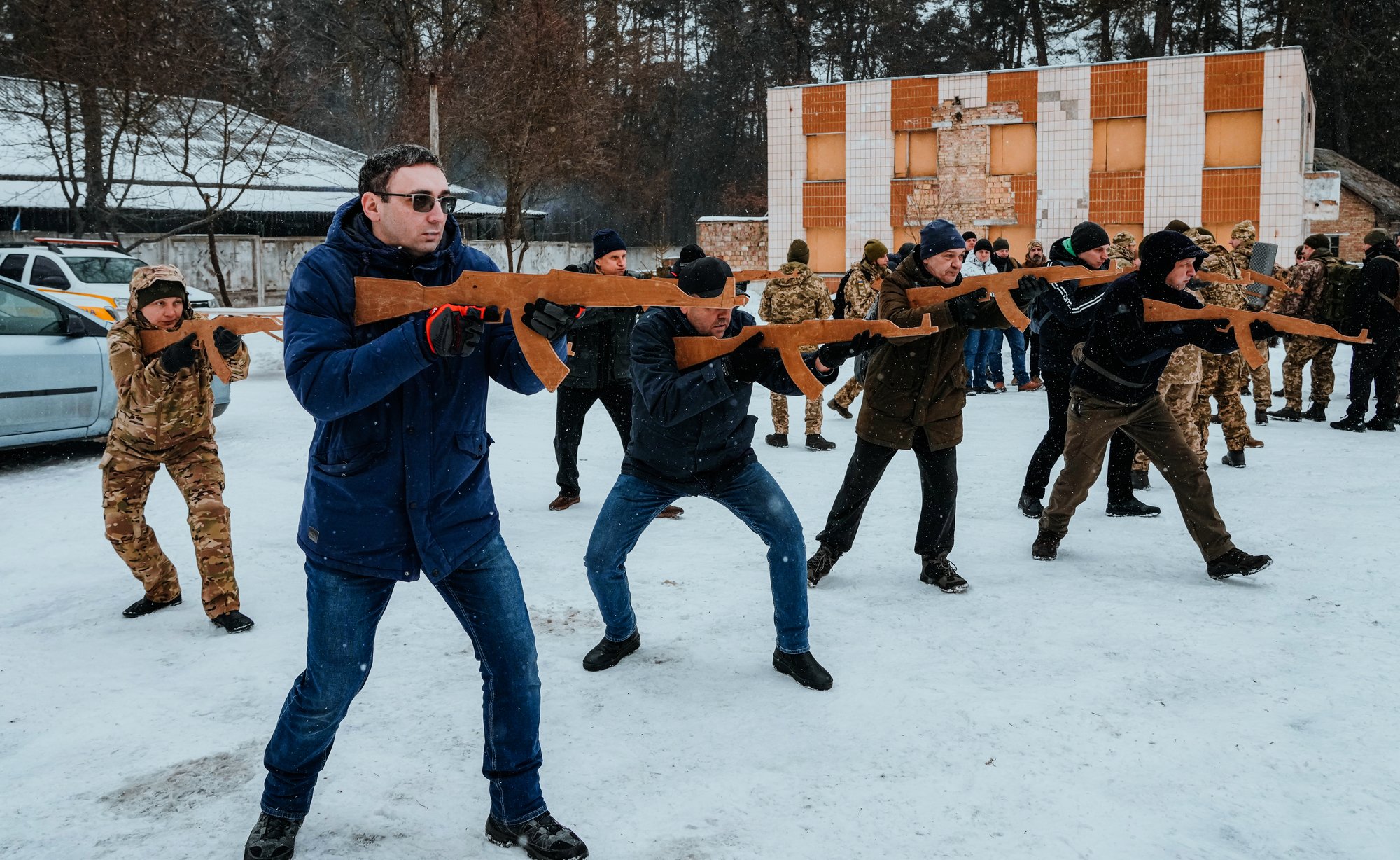 Members of Ukraine's Territorial Defense Forces, volunteer military units of the Armed Forces, train close to Kyiv, Ukraine, Saturday, Feb. 5, 2022. Hundreds of civilians have been joining Ukraine's army reserves in recent weeks amid fears about Russian invasion. (AP Photo/Efrem Lukatsky)