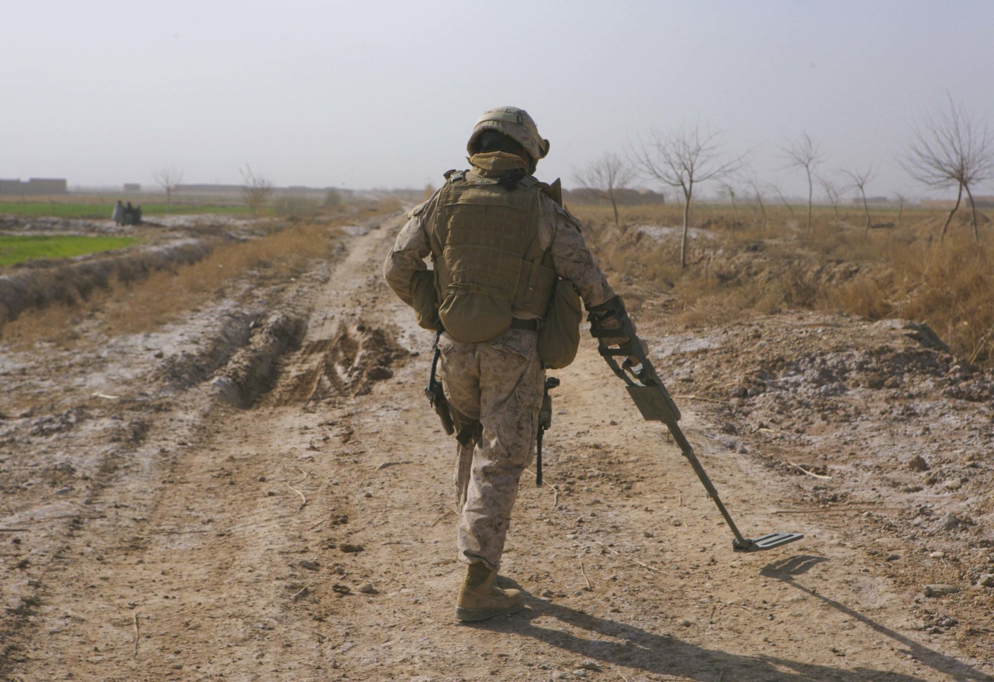 Sgt. Robert Torres, 1st section leader with General Support Security Platoon, Headquarters and Service Company, Combat Logistics Battalion 3, 1st Marine Logistics Group (Forward) sweeps the road for improvised explosive devices before travelling over it to attempt to recover an immobilized Mine Resistant Ambush Protected vehicle in Trek Nawa, Afghanistan, Feb. 25. The vehicle became stuck after a portion of the road it was travelling on gave out. The recovery was in support of 2nd Battalion, 8th Marine Regiment.