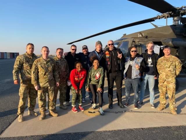 The author and rock band American Hitmen pose for a picture with some of the American service members they entertained overseas. Photo courtesy of Ty Coleman of Rogue Digital.