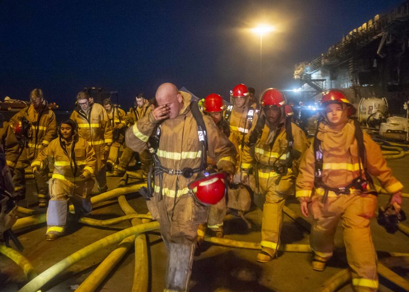 Sailors and Federal San Diego Firefighters fight fire aboard USS Bonhomme Richard