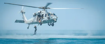 A Navy Explosive Ordnance Disposal Technician jumps from an MH-60S Seahawk helicopter, attached to Helicopter Sea Combat Squadron 26, during International Maritime Exercise/Cutlass Express 2023, in the Persian Gulf, March 14, 2023. US Navy photo by Navy Petty Officer 1st Class Anita Chebahtah.