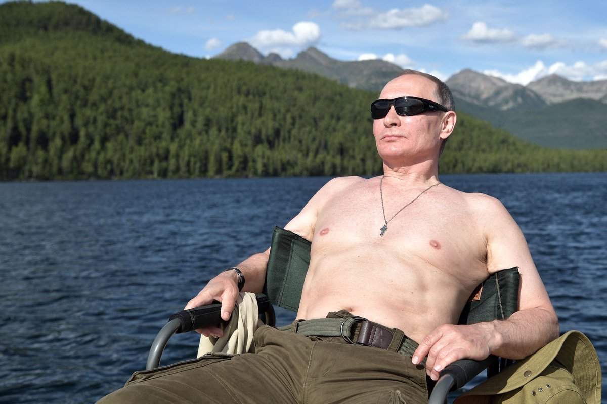 Trying too hard? Russian President Vladimir Putin sunbathes during his vacation in the remote Tuva region in southern Siberia. The picture taken between Aug. 1 and 3, 2017. (Photo by Alexey Nikolsky/ SPUTNIK / AFP via Getty Images.