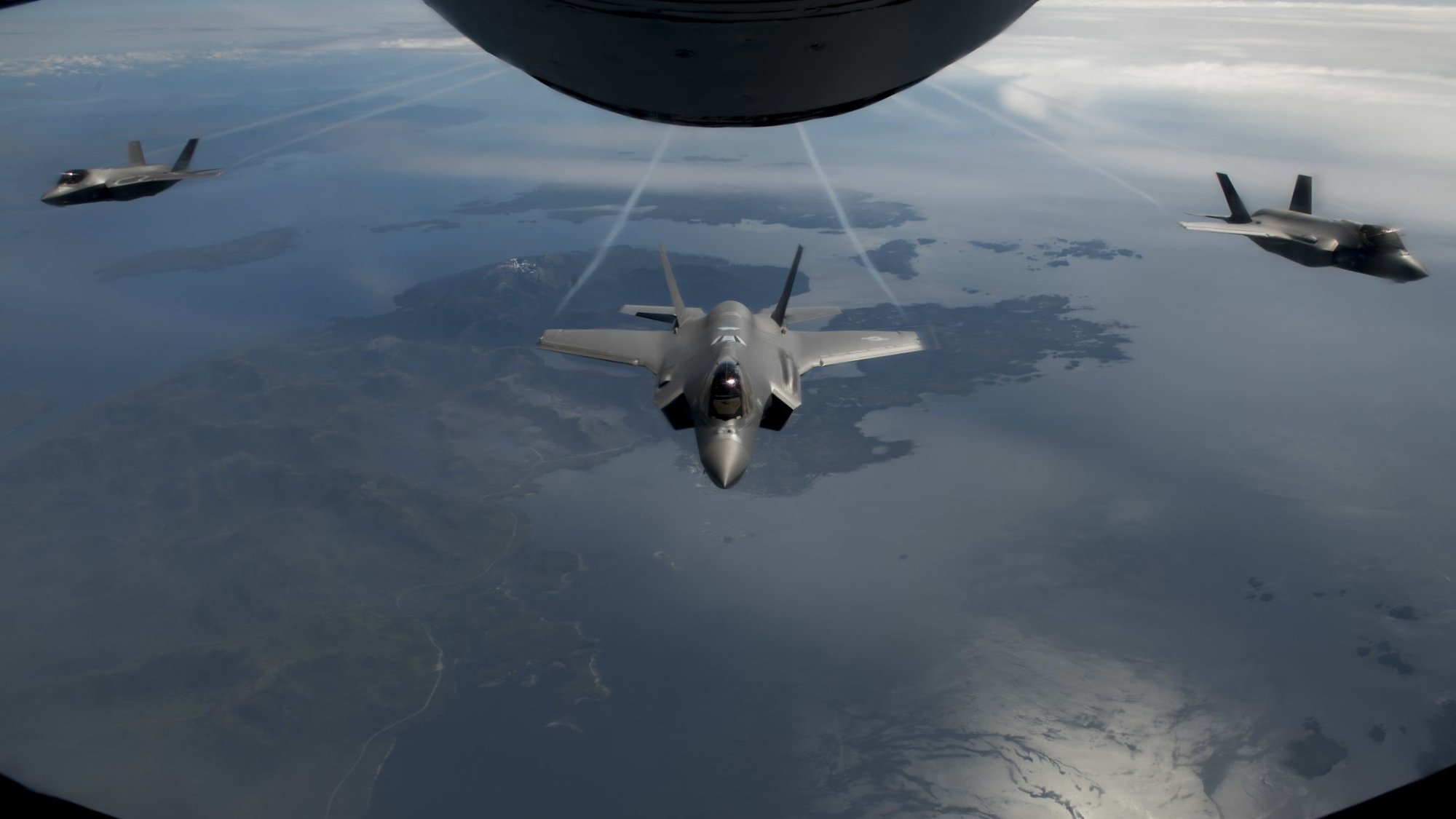 Three F-35 Lightning IIs fly in formation after being refueled by a KC-135 Stratotanker en route to Alaska, July 30, 2020. The F-35A is an agile, versatile, high-performance, 9g capable multirole fighter that combines stealth, sensor fusion, and unprecedented situational awareness. (U.S. Air Force photo by Senior Airman Lawrence Sena)