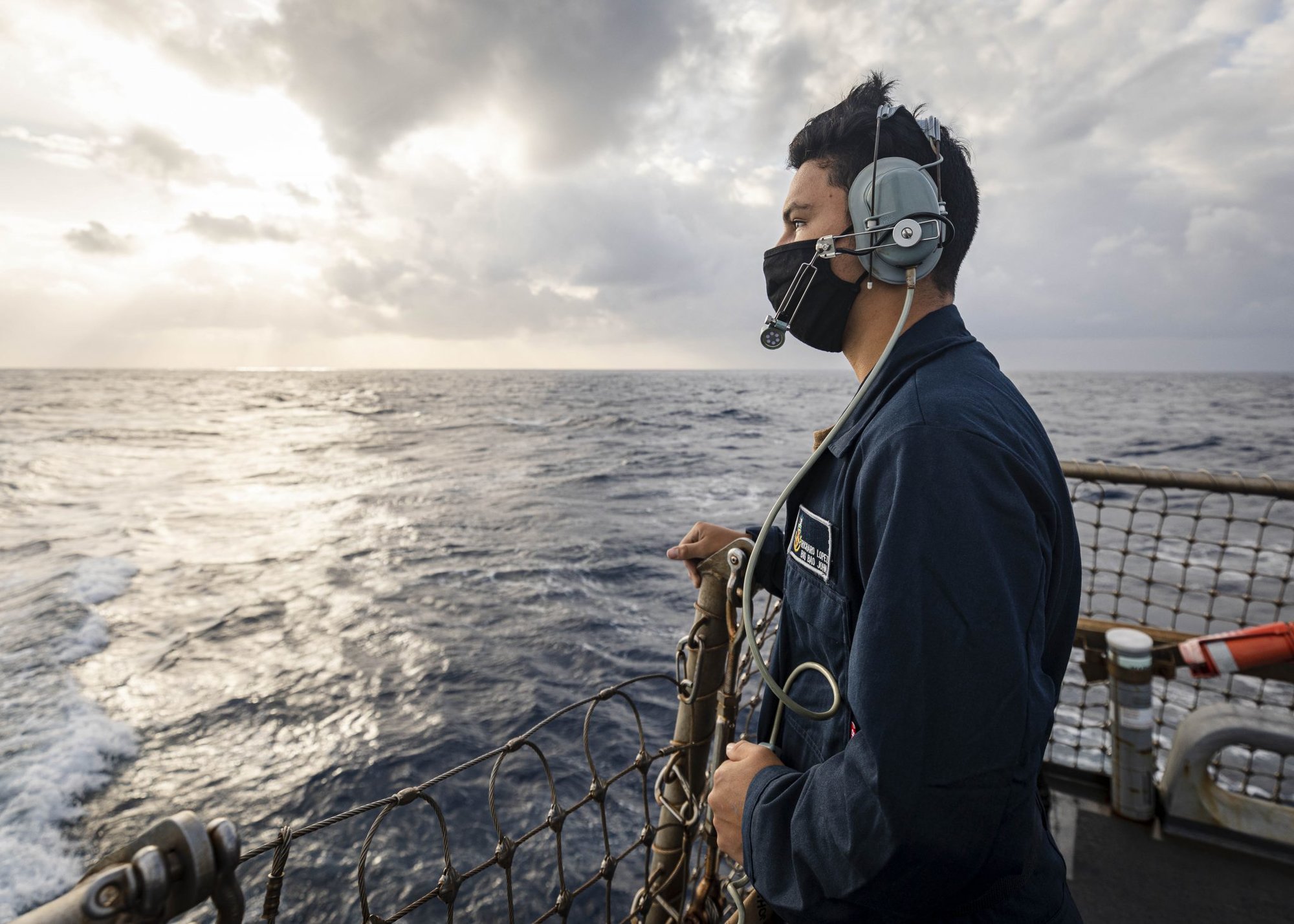 Indo-Pacific doubleheader, PARACEL ISLANDS, SOUTH CHINA SEA (Feb. 05, 2021) Seaman Recruit Richard Lopez, from Tulare, Calif., stands watch as aft lookout on the flight deck aboard the Arleigh Burke-class guided-missile destroyer USS John S. McCain (DDG 56) as the ship conducts routine underway operations. Photo by Mass Communication Specialist 2nd Class Markus Castaneda.