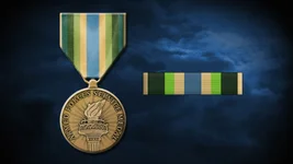 Each color on the Armed Forces Service Medal symbolizes something different: green for life and growth; medium blue for the Department of Defense; and gold to denote honor. US Air Force graphic by Staff Sgt. Alexx Pons.