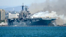 Port of San Diego Harbor Police Department boats combat a fire sweeping the amphibious assault ship Bonhomme Richard at Naval Base San Diego on July 12, 2020. The Wasp-class vessel was undergoing what the US Navy calls a maintenance availability, which began in 2018 and was expected to revamp the warship. US Navy photo by Lt. John J. Mike via Getty Images.