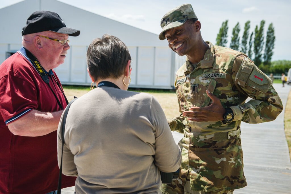 U.S. Army Lieutenant Alix Idrache is interviewed by French media during a tour of the U.S. Army Europe logistics support area at Hippodrome Maurice de Folleville in Carentan, France, June 1, 2019. Photo by Sgt. Henry Villarama/ U.S. Army Europe, courtesy of DVIDS.