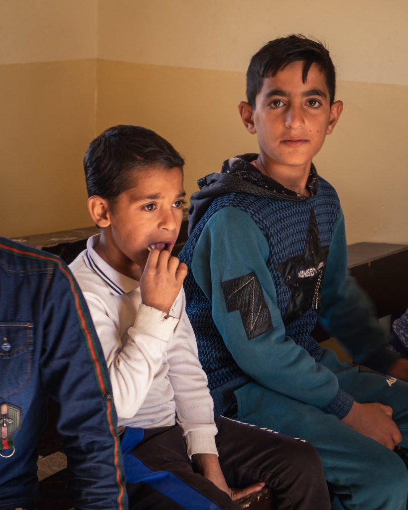 Children of the village sit in one of two rooms that compose the village school or “madraseh” in Arabic. There, they learn arithmetic, reading and religious studies.