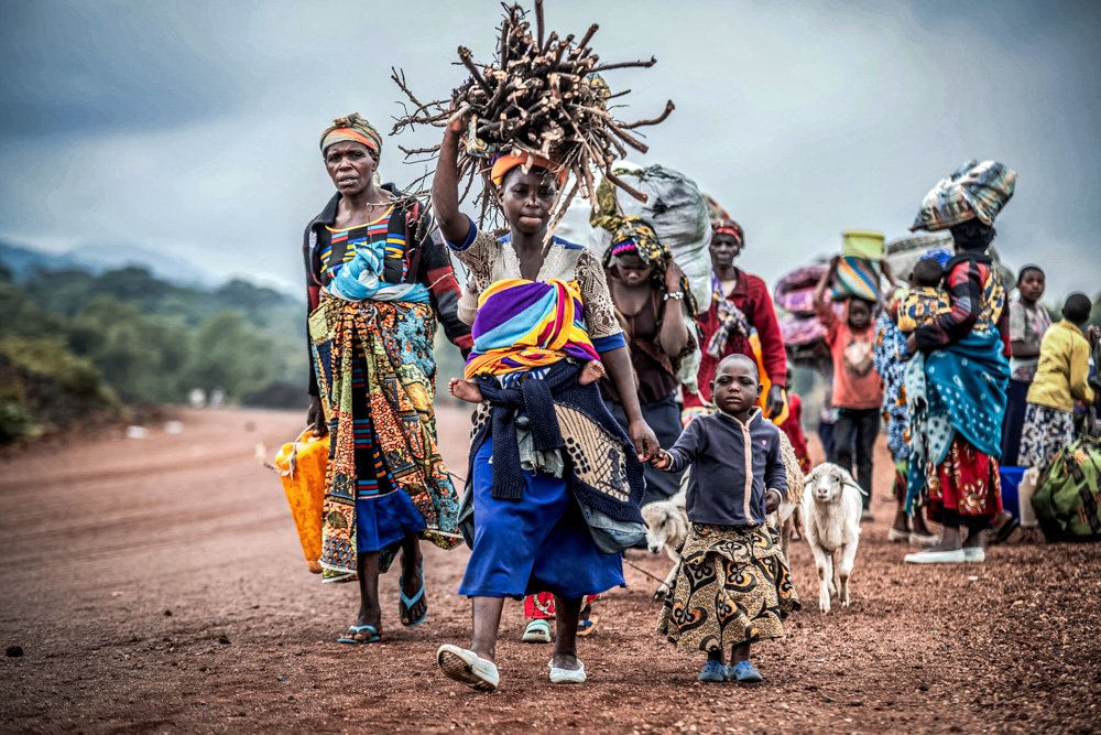 Residents flee fighting between M23 rebels and Congolese forces near Kibumba, some 20 kms (12 miles) North of Goma.