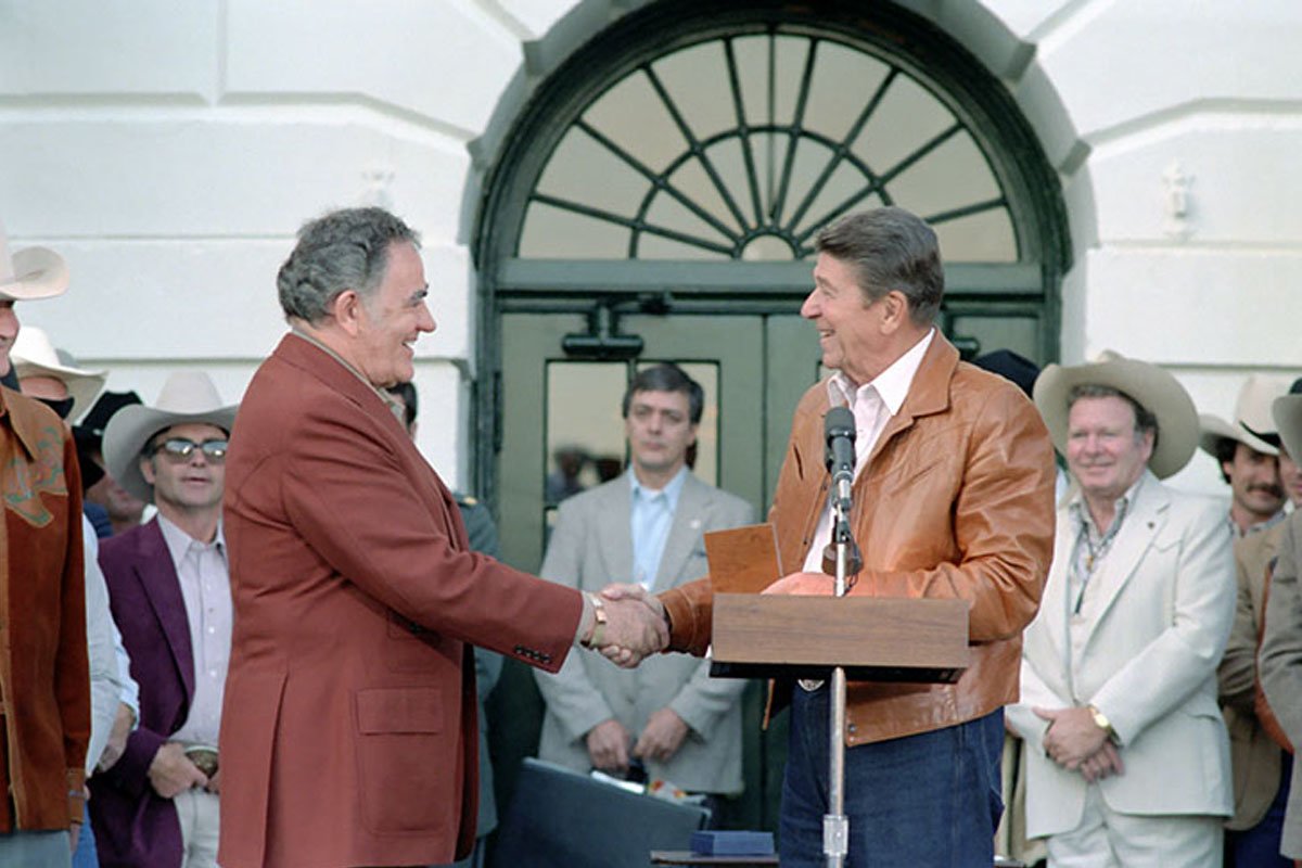 9/24/1983 President Reagan presenting Congressional Gold medal to Louis L'Amour at Barbecue for Professional Rodeo Cowboys Association on South Lawn. Photo courtesy of the White House/Ronal Reagan Presidential Library.