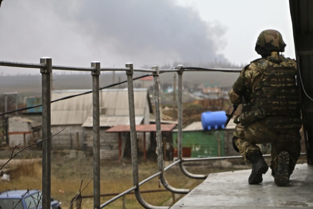 A Ukrainian soldier keeps watch in the town of Shyrokyne. Photo by Nolan Peterson/Coffee or Die.