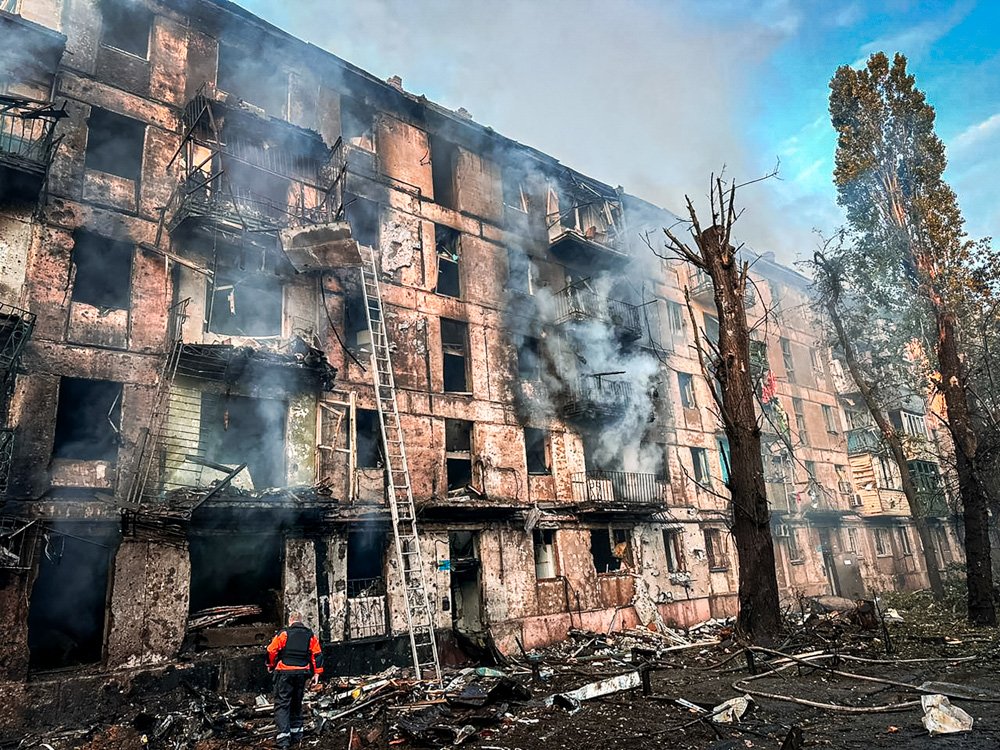 In this photo released by Dnipro Regional Administration, emergency workers extinguish a fire after missiles hit a multi-story apartment building in Kryvyi Rih, Ukraine.