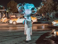 A balloon seller stands in the middle of a street of Mazar-i-Sharif in northern Afghanistan on Aug. 12, 2021. Photo by Jacob Simkin.