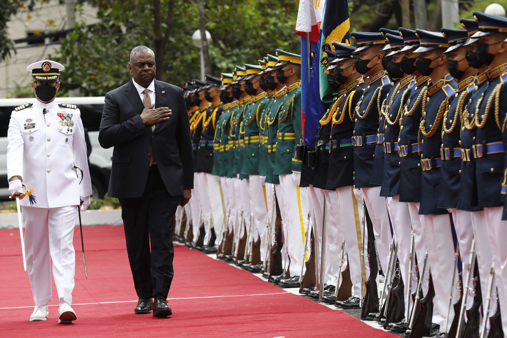 U.S. Defense Secretary Lloyd Austin, second from left, walks past military guards during his arrival at the Department of National Defense in Camp Aguinaldo military camp in Quezon City, Metro Manila, Philippines on Thursday February 2, 2023. Rolex Dela Pena/Pool Photo via AP.