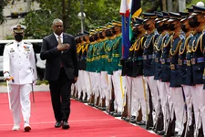 U.S. Defense Secretary Lloyd Austin, second from left, walks past military guards during his arrival at the Department of National Defense in Camp Aguinaldo military camp in Quezon City, Metro Manila, Philippines on Thursday February 2, 2023. Rolex Dela Pena/Pool Photo via AP.