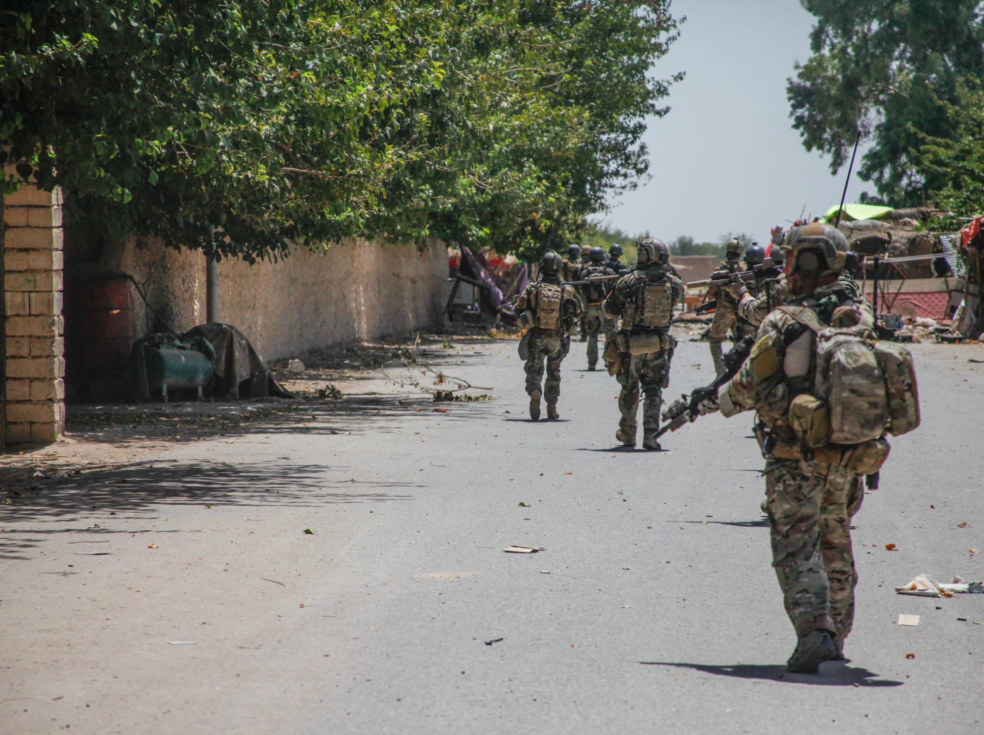 U.S. Special Forces Soldiers, attached to Special Operations Task Force-Afghanistan, along side Afghan National Army Commandos, from 7th and 9th Special Operations Kandak, clear a large alleyway during an operation in the Chanjir district, Helmand province, Afghanistan, Aug. 23, 2016.  The operation was conducted to help Afghan Partner units take back a district center that was overrun by the Taliban in the area. (U.S. Army photo by Sgt. Connor Mendez/Reviewed)