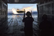 140625-N-SU278-009
PACIFIC OCEAN (June 25, 2014) Boatswain’s Mate 2nd Class Brooks Graham, from Ludington, Mich., directs a landing craft air cushion (LCAC) assigned to Amphibious Craft Unit (ACU) 5 into the well deck of the amphibious assault ship USS Peleliu (LHA 5) following a training exercise. Peleliu is en route to Hawaii to participate in Rim of the Pacific (RIMPAC) 2014. Twenty-two nations, more than 40 ships and submarines, more than 200 aircraft and 25,000 personnel are participating in RIMPAC exercise from June 26 to Aug. 1. (U.S. Navy photo by Mass Communication Specialist 3rd Class Will Gaskill/Released)