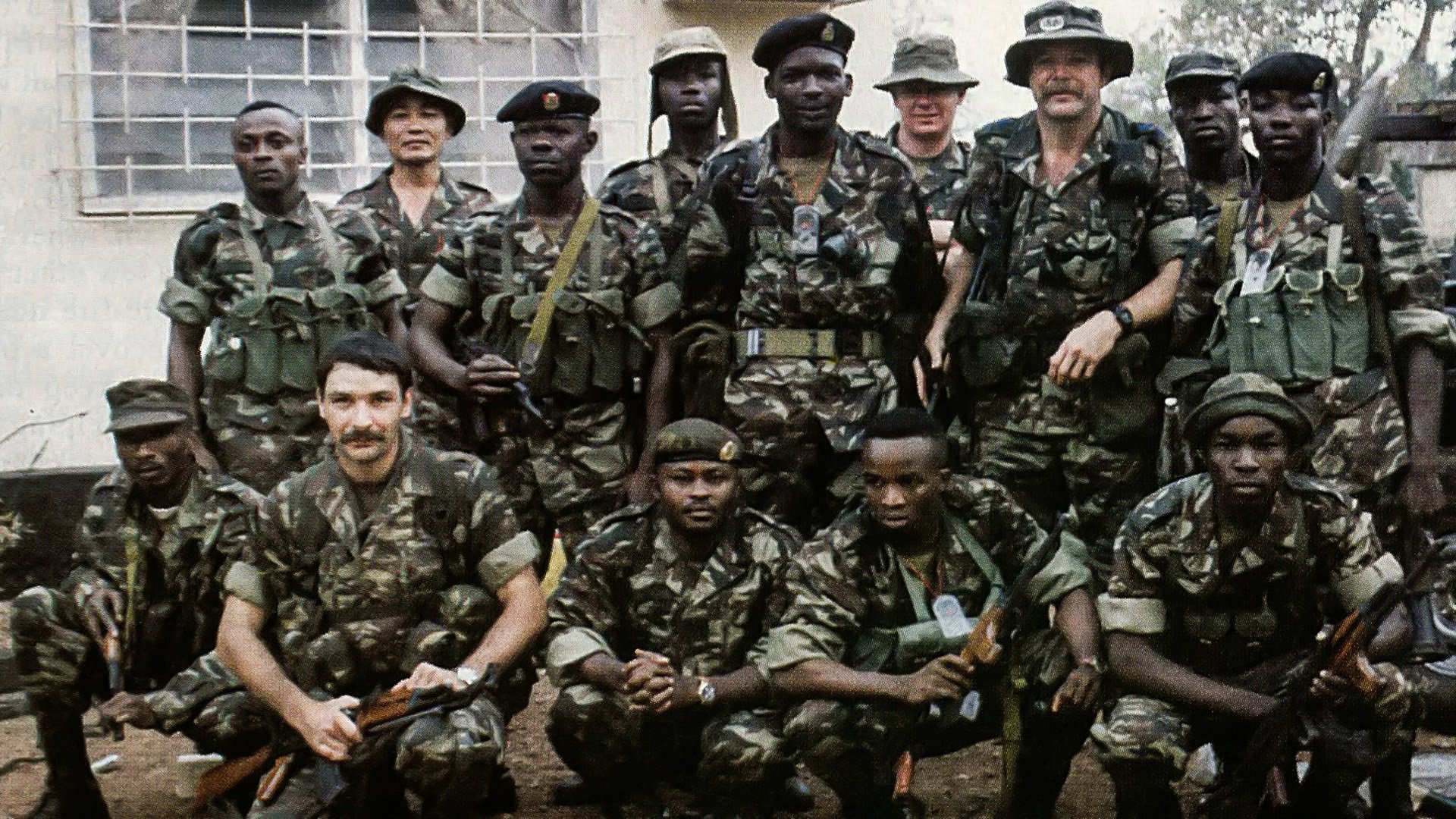 Lt. Col. Robert C. MacKenzie (standing, wings on hat) with some of the Sierra Leone Commando Unit he was training with the Gurkha Security Guards. Lt Andy Myers is 2nd from left, kneeling. Wikimedia Commons photo