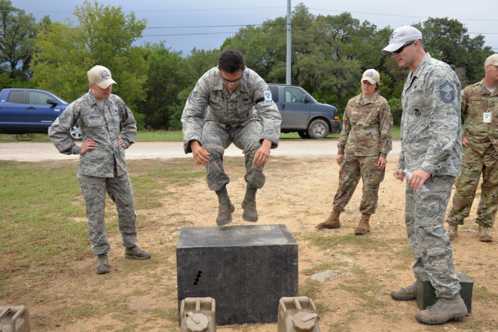 Senior Airman Lorenzo Fonseca, Air Force Reserve Command Defender Challenge team member, performs 25 repetitions of jumping from the ground to the box during the combat endurance relay Sept. 13, 2018, at Camp Bullis Military Training Reservation, Texas. Photo by Master Sgt. Kristian Carter, courtesy of the U.S. Army.