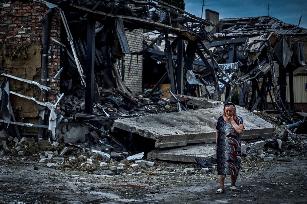 A woman reacts at the scene of a building damaged after recent Russian missile strikes