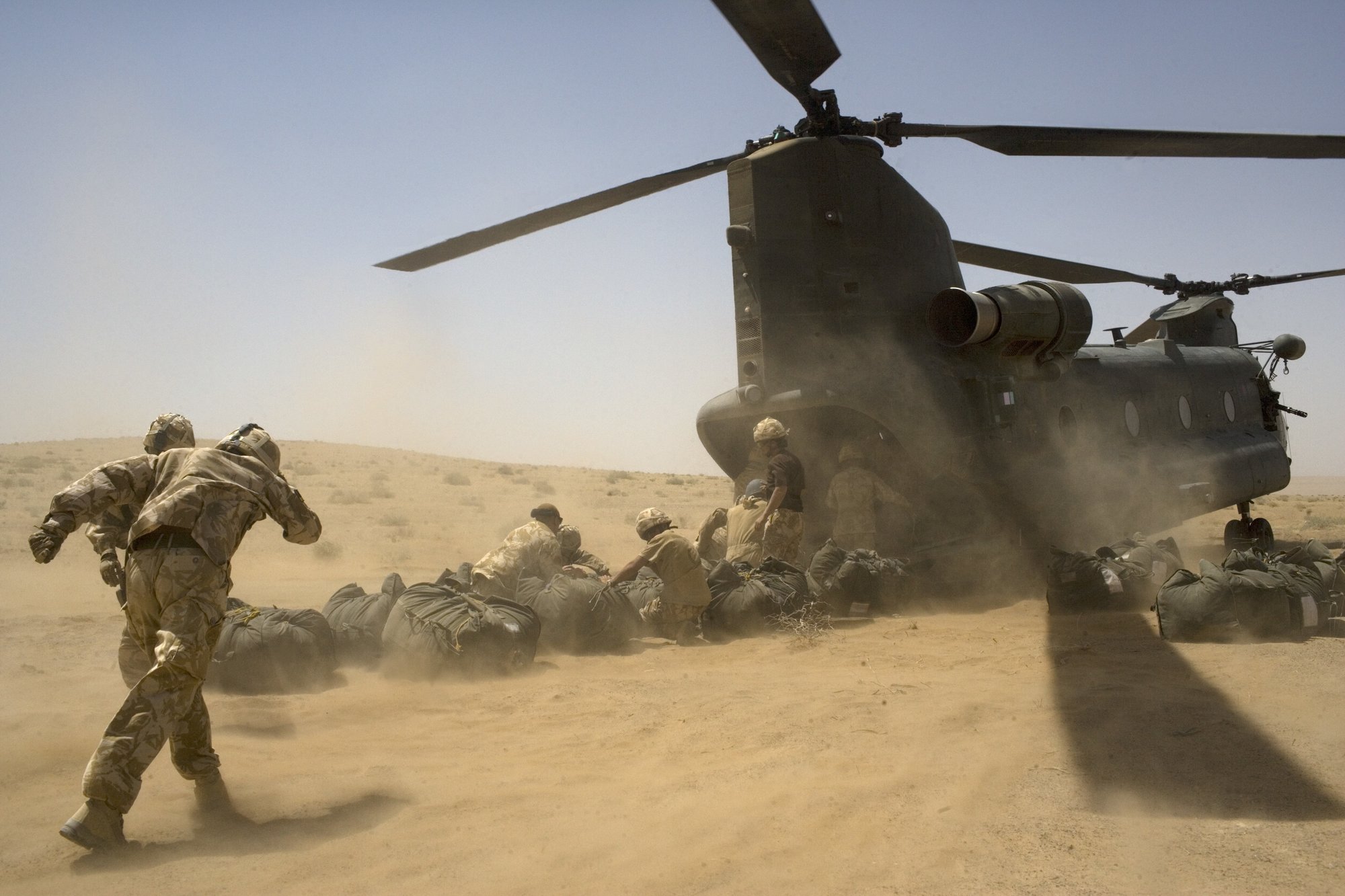 British soldiers load into a Chinook helicopter delivering supplies as they camp in a location in the desert to conduct counter-Taliban operations May 25, 2007, in southern Helmand province, Afghanistan. Photo by Marco Di Lauro via Getty Images.