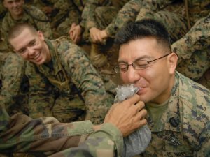 Petty Officer 3rd Class Charles Edkins, a hospital corpsman from 3rd Marine Division, braves some mystery fruit pulp.