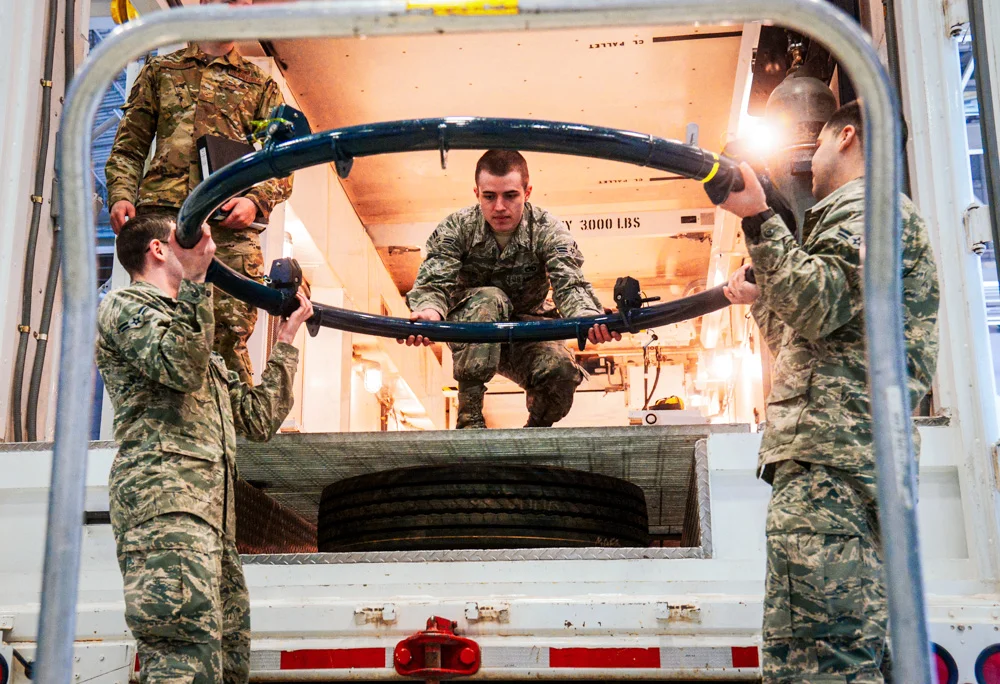 Airmen from the 341st Missile Maintenance Squadron prepare a payload transporter.