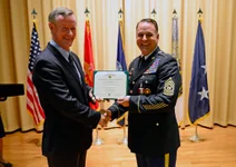 Retired Adm. William H. McRaven, former commander of US Special Operations Command, presents Command Sgt. Major Chris Faris the Distinguished Service Medal during Faris’ retirement ceremony at MacDill Air Force Base, Fla. USSOCOM photo by Mike Bottoms.