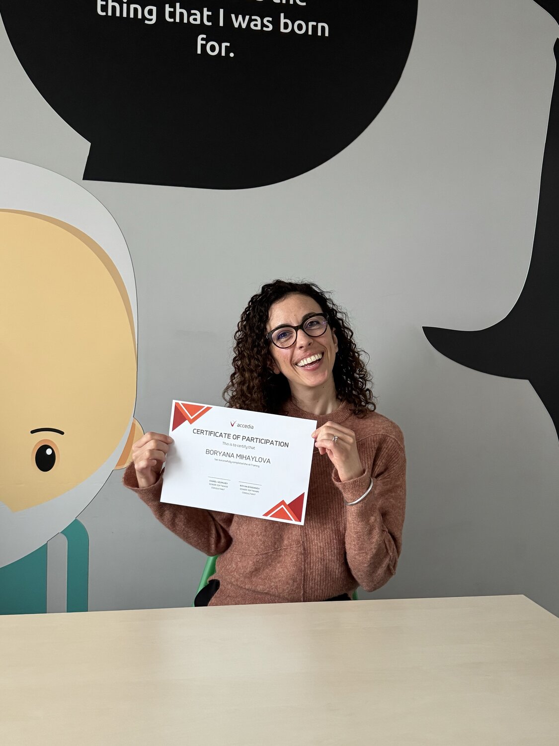 Accedia Software Consultant Boryana Mihaylova proudly holding a certificate after completing the internal AI training program.