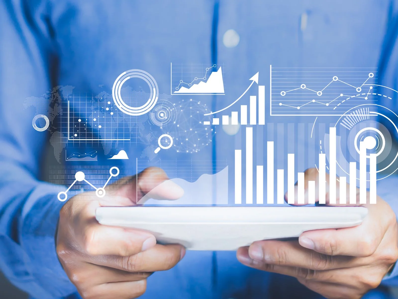 Close-up of a person holding a tablet displaying digital graphs and data visualizations, representing AI, data science, and analytics