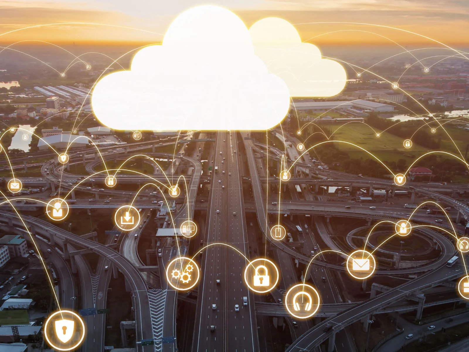 A cloud icon symbolizing cloud data storage hovers over a complex highway system at sunset, illustrating the interconnectedness and scalability of cloud solutions compared to traditional on-premises servers