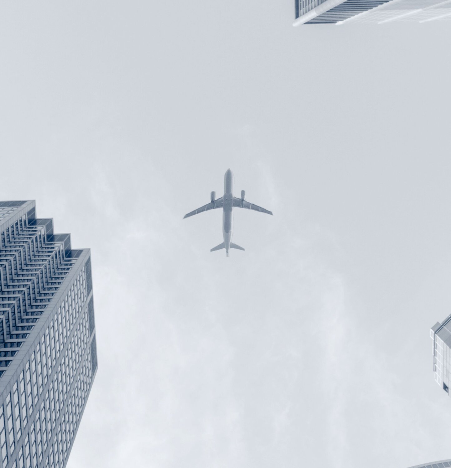 airplane above skyscrapers