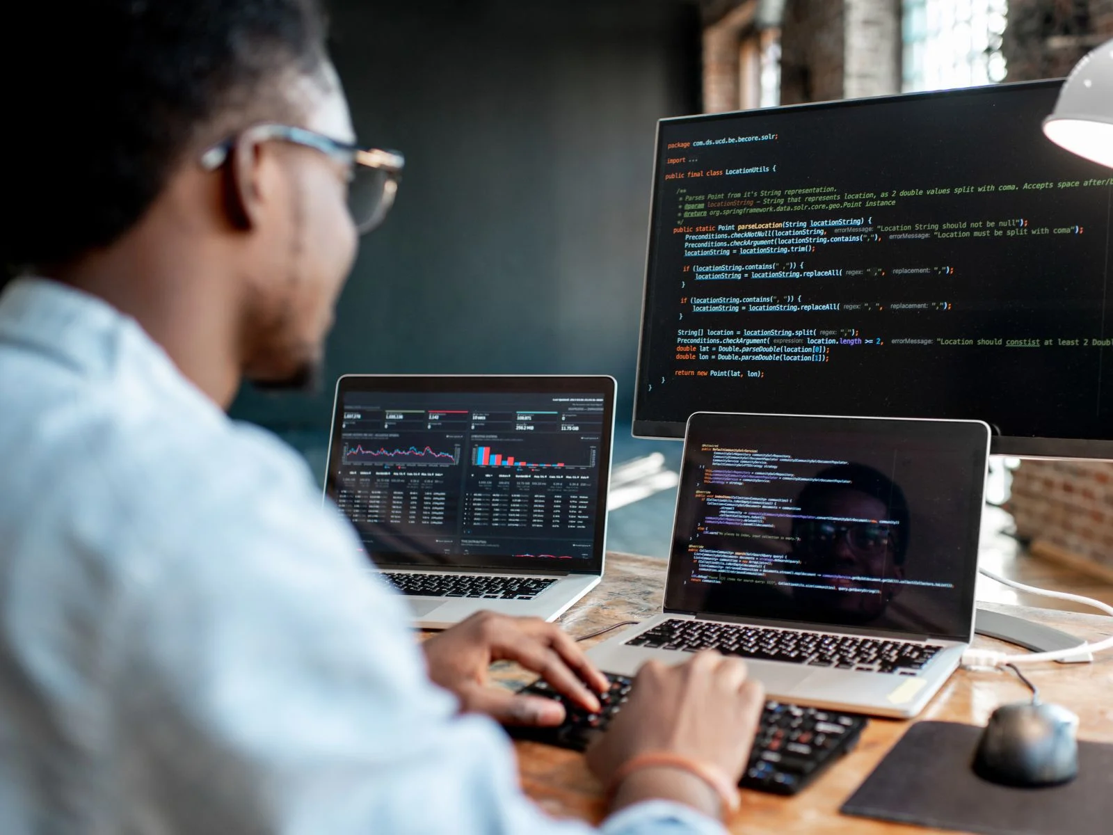 A developer working on code displayed across multiple screens, related to .NET 6 features