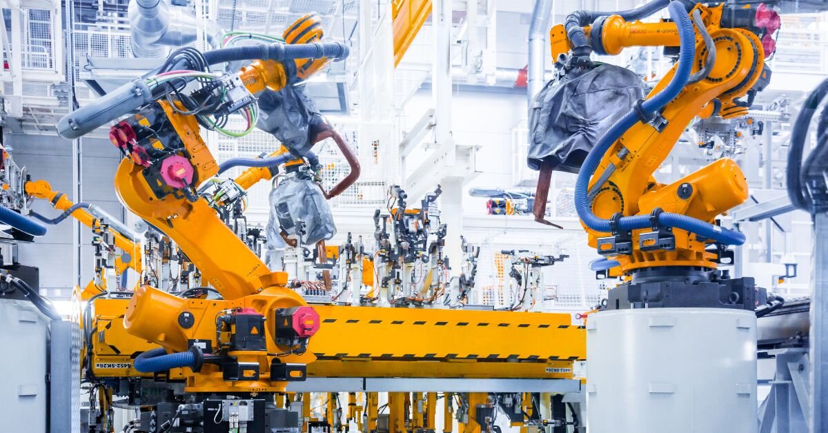 Industrial robots operating in a manufacturing facility, illustrating the use of AI and automation in modern manufacturing processes