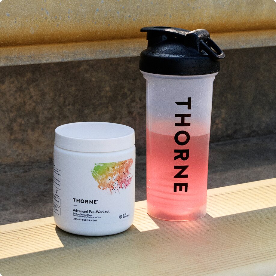 Thorne shaker bottle with jar of advanced pre-workout on bench
