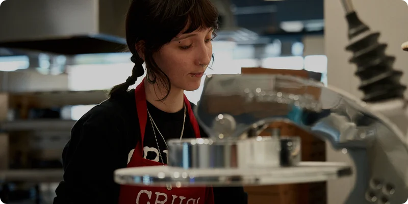 A restaurant worker preparing food in a commercial kitchen