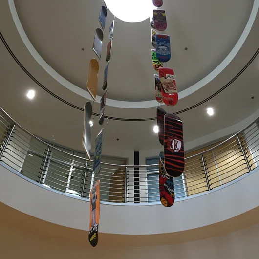 <!--vansca-->

We started our trip at the Sole Tech HQ. Front and center when you walk in is a ton of history from their decades in skateboarding. I thought these boards hanging from the ceiling were pretty cool and wanted to make some offers on that Ellington board for my personal board wall.