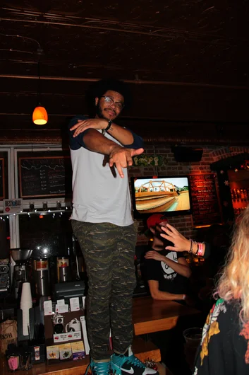 <!--ta14-sn-->
After the smoke had cleared, it was time to hit Ybor again.  Rarely is anyone allowed to be on top of the bar, but Tampa Am is a rare occasion.  That's Louis Jr. on the Bricks bar.