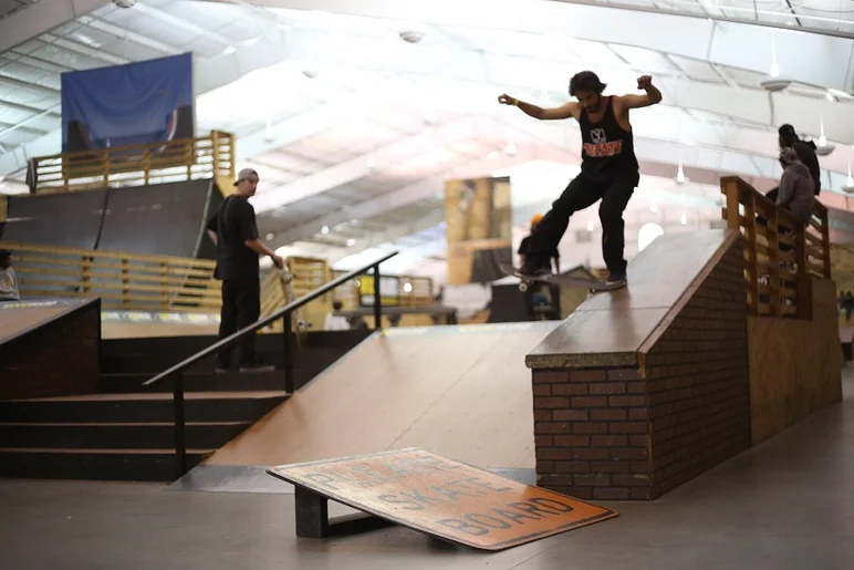 <!-- woodwardwest2013 -->

Please skate board? Felipe Gouveia had no problem skating with this nose slide into the bank.