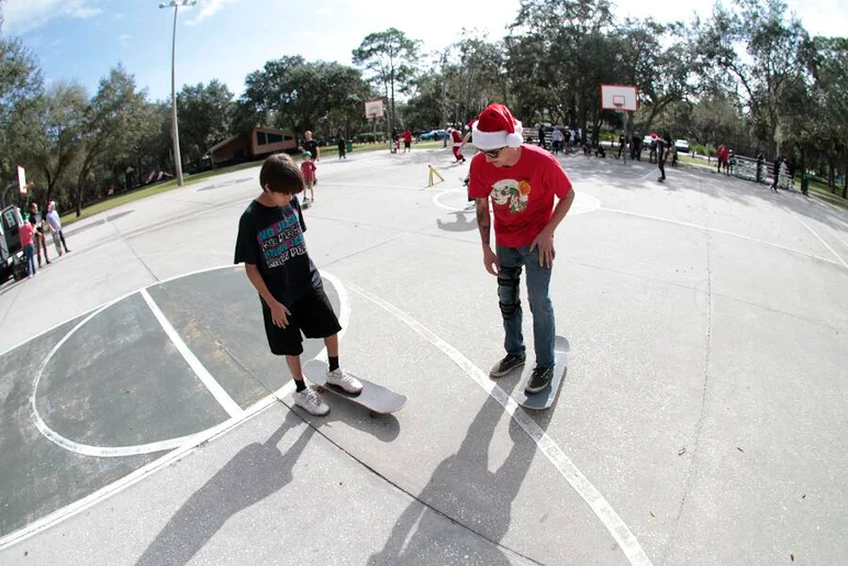 <!-- b4b2013dec -->

The first spot we went to was a basketball court, here's Casey Wayne teaching this kid how to skate after giving him his first board.