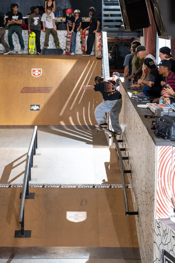 Noah dropping jaws with a first try back crook on the wall rail

<!--schoolsoutjam22-->