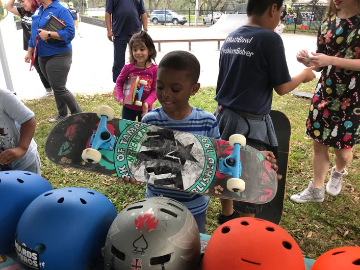 <!--b4bdesoto-->

This kid is either really admiring his new gift, or trying to figure out which helmet would go best with it...