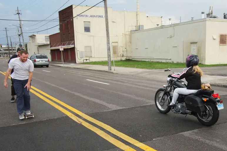 Biker lady in heels swerves around Pat Stiener.<!-- Booze Cruise: September 2012 -->